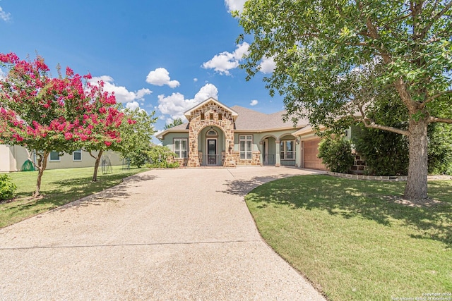 view of front of house with a front yard and a garage