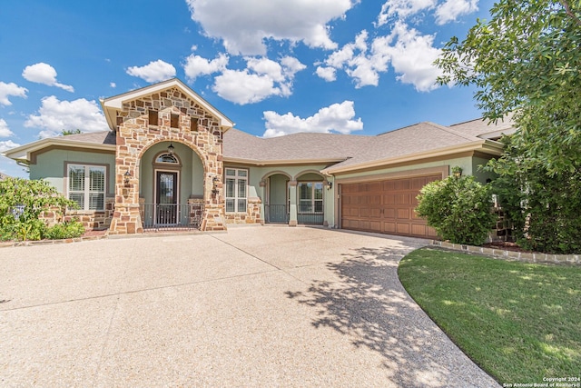 view of front of house with a garage and a front lawn