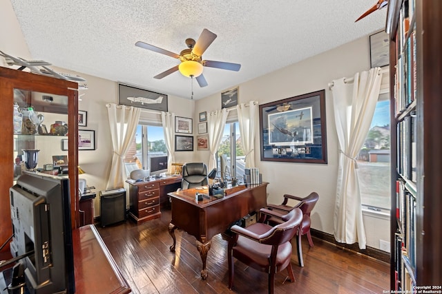 home office featuring ceiling fan, dark hardwood / wood-style floors, and a textured ceiling