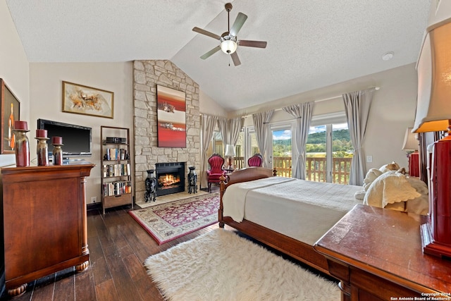 bedroom with ceiling fan, dark hardwood / wood-style flooring, vaulted ceiling, access to outside, and a textured ceiling