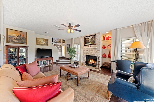 living room featuring a healthy amount of sunlight, hardwood / wood-style floors, and a textured ceiling