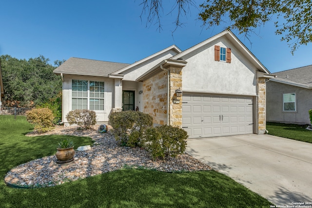 single story home with a garage and a front lawn