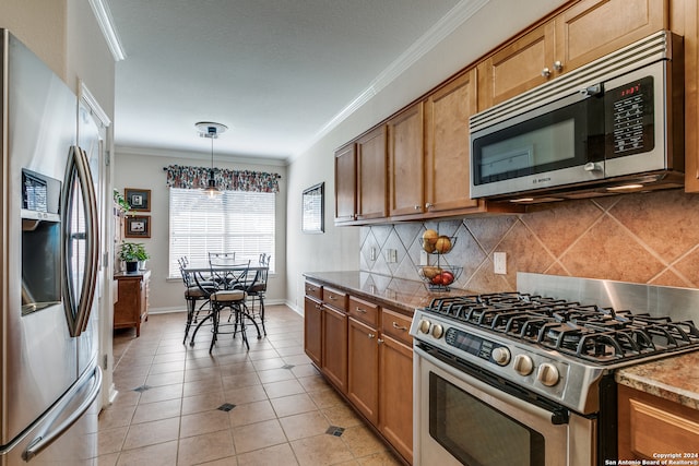 kitchen with light tile patterned flooring, stainless steel appliances, backsplash, and ornamental molding