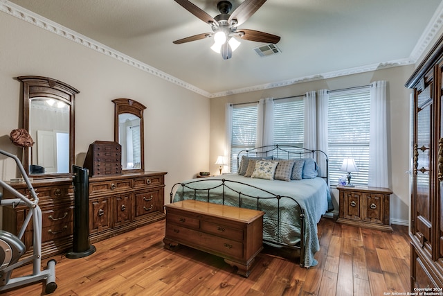 bedroom featuring ornamental molding, hardwood / wood-style floors, and ceiling fan