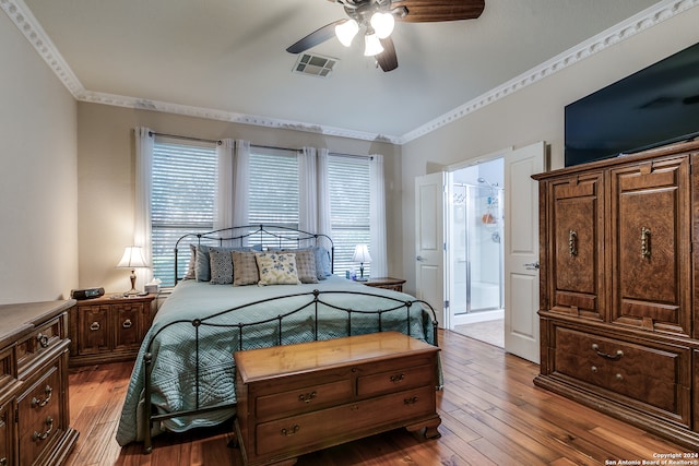 bedroom with ornamental molding, hardwood / wood-style floors, ensuite bathroom, and ceiling fan