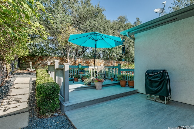 view of patio featuring a wooden deck and area for grilling