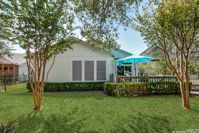 back of house with a lawn