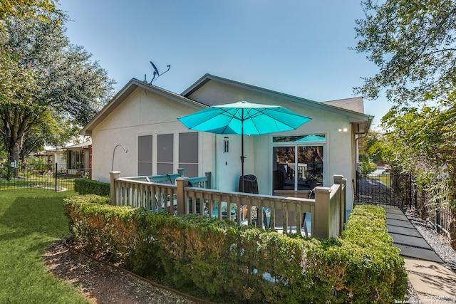 back of house featuring a lawn and a patio area