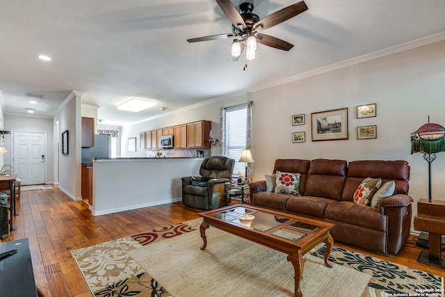 living room featuring ceiling fan, light hardwood / wood-style flooring, and ornamental molding