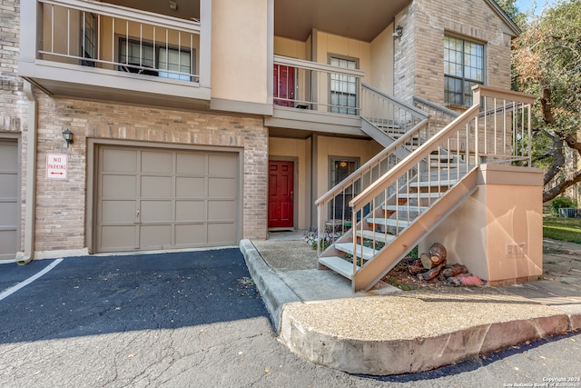 entrance to property featuring a balcony and a garage