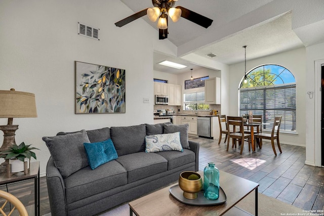 living room featuring ceiling fan, hardwood / wood-style flooring, and sink