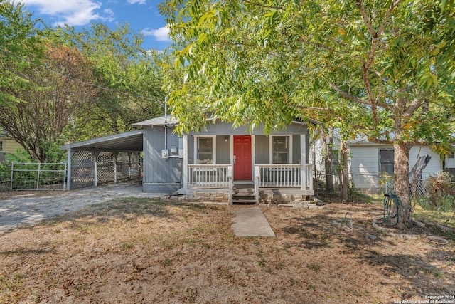 view of front of home featuring a porch and a carport