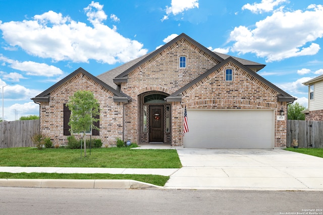 view of front of property featuring a front lawn and a garage