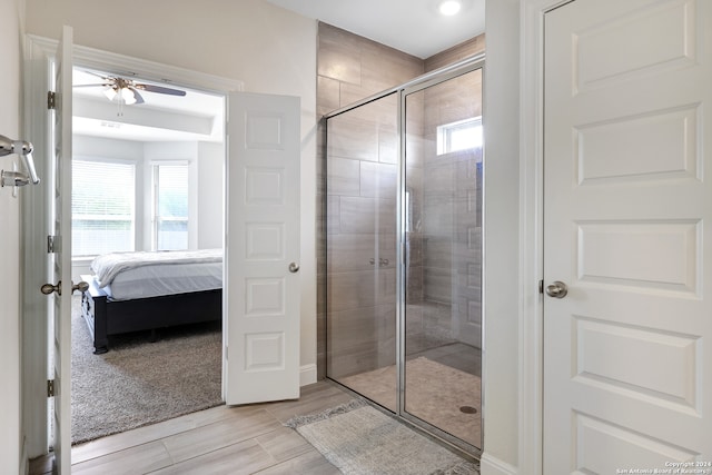 bathroom featuring an enclosed shower, a wealth of natural light, and ceiling fan