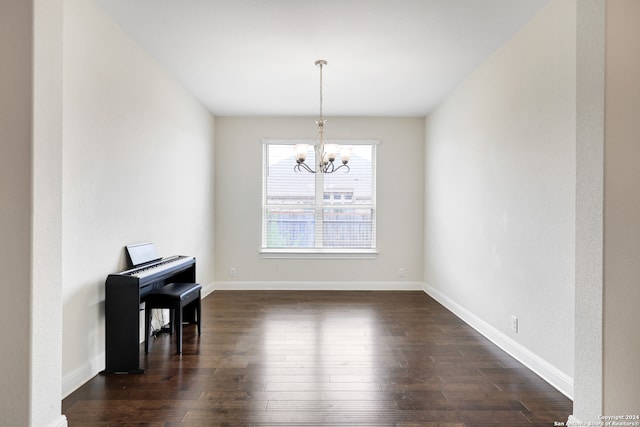 dining space featuring dark hardwood / wood-style floors and a chandelier