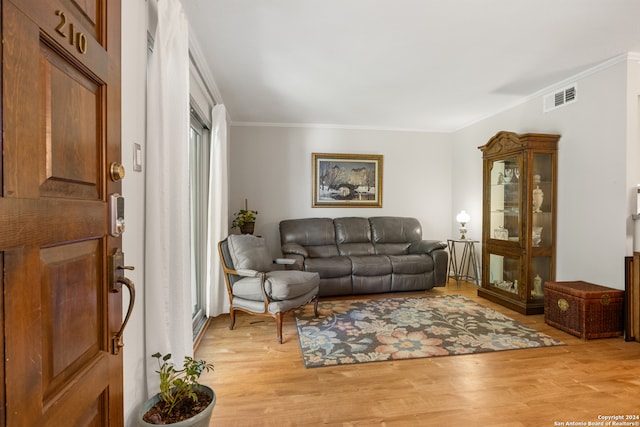 living room with hardwood / wood-style floors and ornamental molding