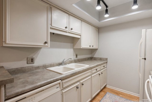 kitchen featuring white cabinets, white appliances, sink, and light hardwood / wood-style flooring