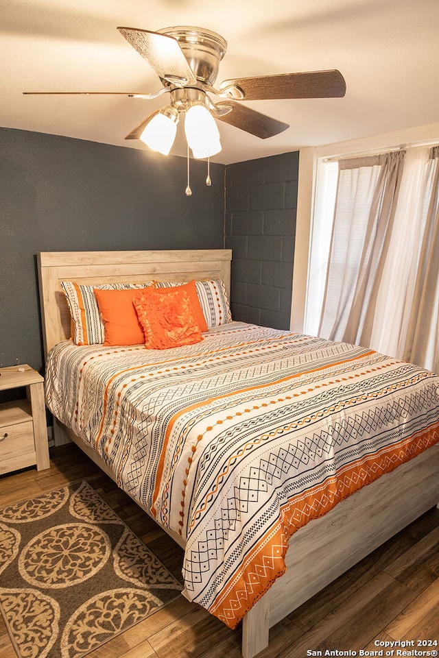 bedroom featuring hardwood / wood-style flooring and ceiling fan