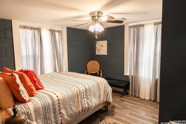 bedroom with ceiling fan and hardwood / wood-style floors