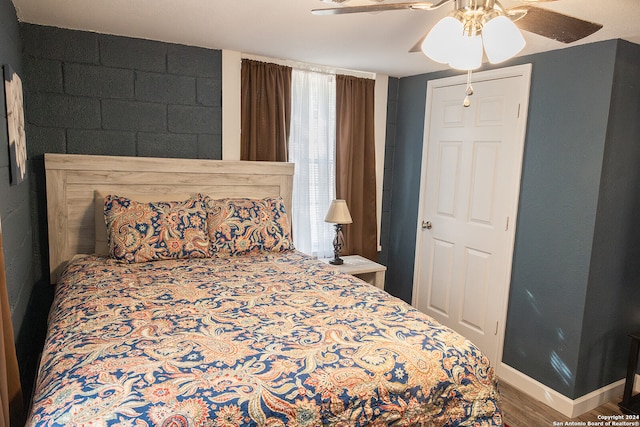 bedroom featuring wood-type flooring and ceiling fan