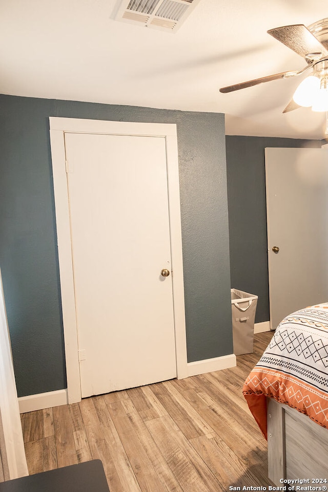 bedroom featuring hardwood / wood-style floors and ceiling fan