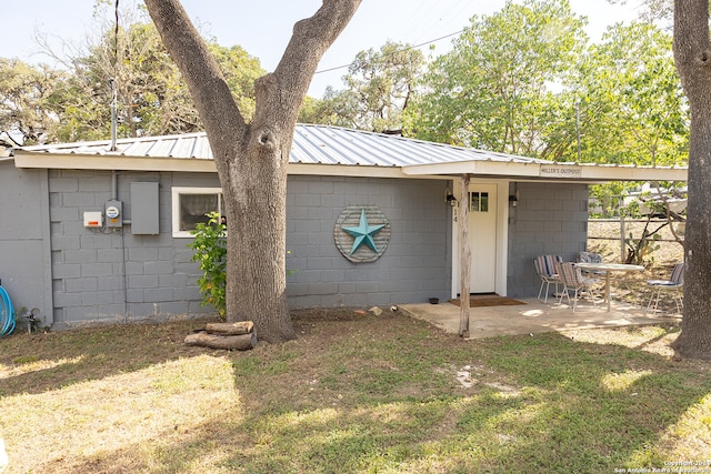 back of property featuring a yard and a patio