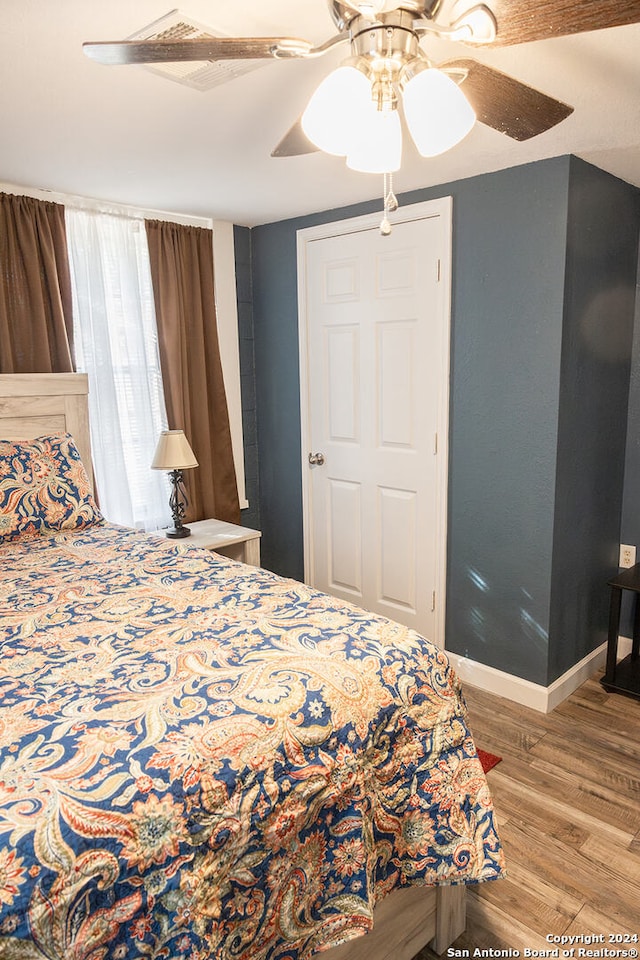 bedroom with light wood-type flooring and ceiling fan