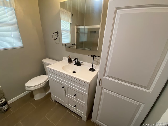 bathroom with vanity, tile patterned flooring, and toilet