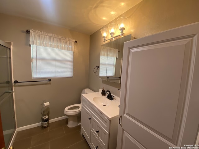 bathroom featuring tile patterned flooring, walk in shower, vanity, and toilet