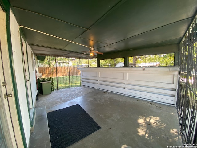 unfurnished sunroom with ceiling fan