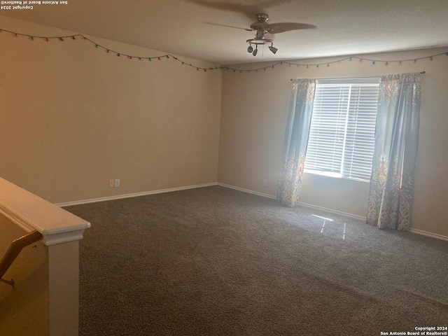 unfurnished room featuring ceiling fan, carpet floors, and a textured ceiling