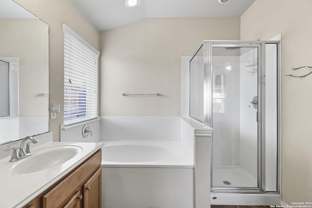 bathroom featuring vanity, plus walk in shower, and vaulted ceiling