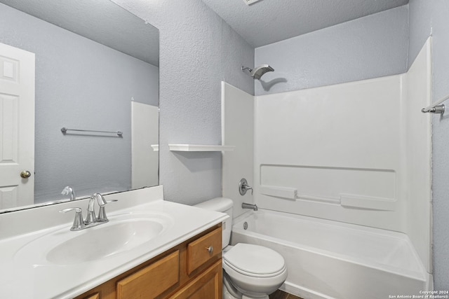 full bathroom with vanity, a textured ceiling, toilet, and shower / bathtub combination