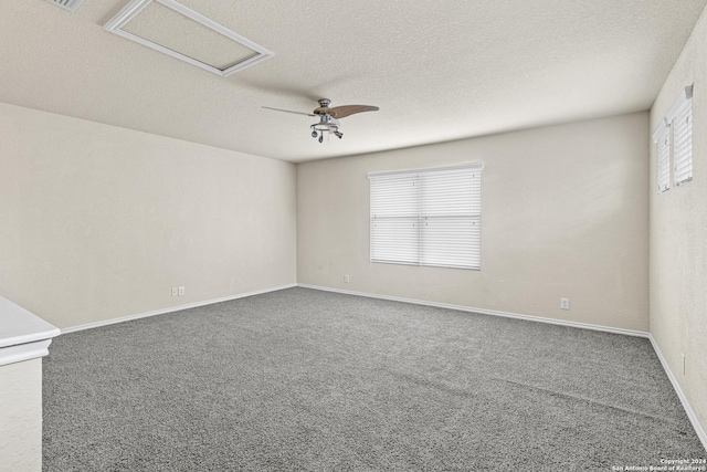 carpeted spare room with ceiling fan, plenty of natural light, and a textured ceiling