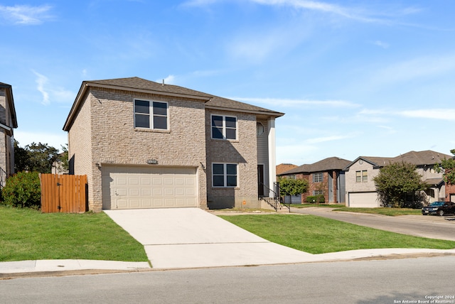 view of property featuring a front yard and a garage