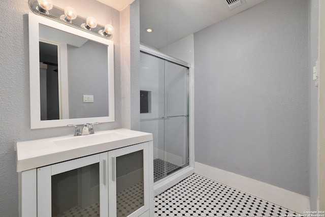722 E Drexel Ave, San Antonio, TX 78210 - full bathroom featuring a shower stall, vanity, and baseboards