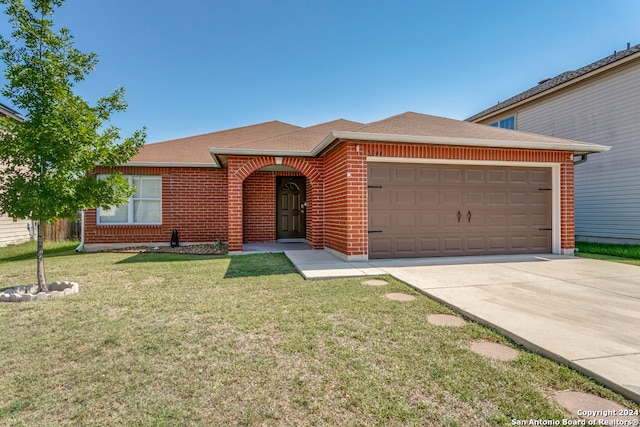 view of front of property with a garage and a front lawn