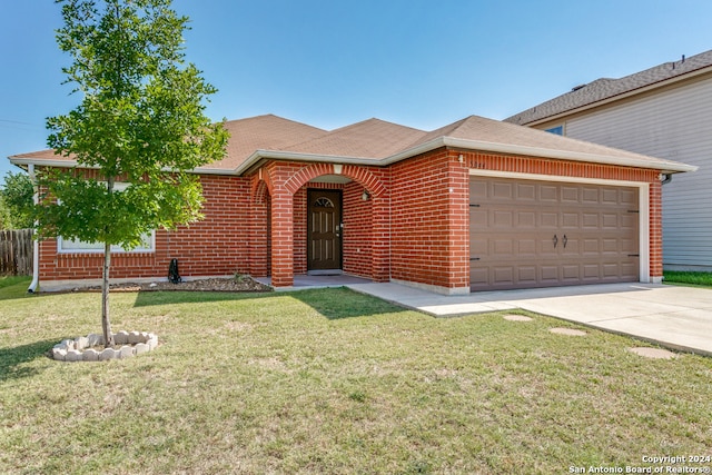 view of front of house featuring a garage and a front lawn