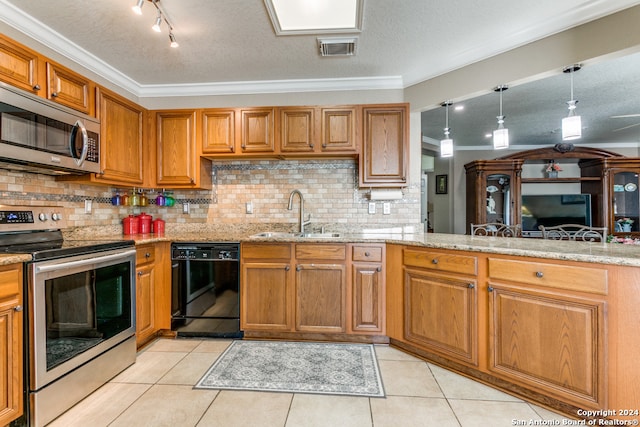 kitchen featuring decorative light fixtures, sink, light stone counters, stainless steel appliances, and ornamental molding