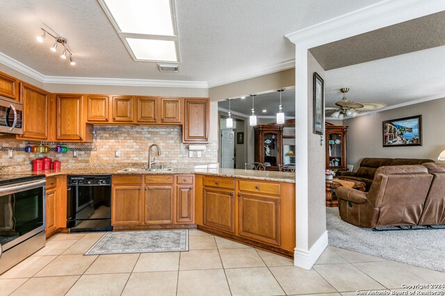 kitchen with ornamental molding, sink, stainless steel appliances, and light tile patterned flooring