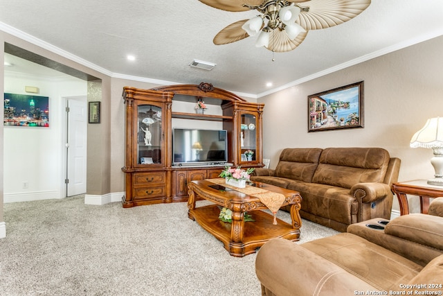 carpeted living room featuring ceiling fan, ornamental molding, and a textured ceiling