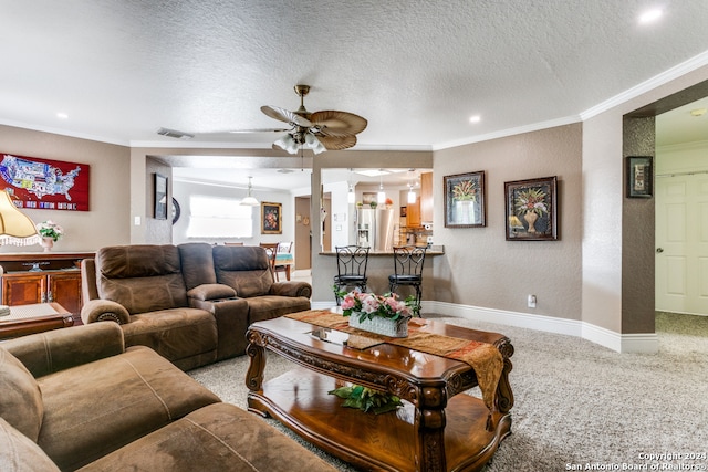 carpeted living room featuring crown molding, a textured ceiling, and ceiling fan