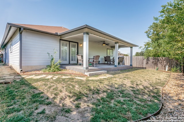 rear view of house featuring a patio area, a lawn, and ceiling fan