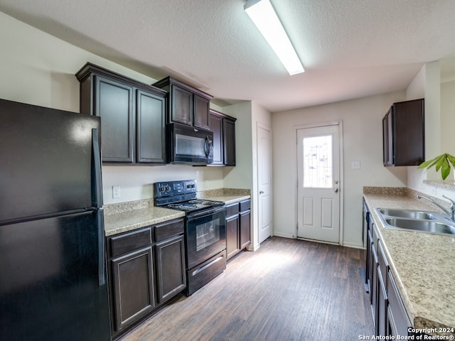 kitchen with light hardwood / wood-style flooring, dark brown cabinets, sink, black appliances, and a textured ceiling