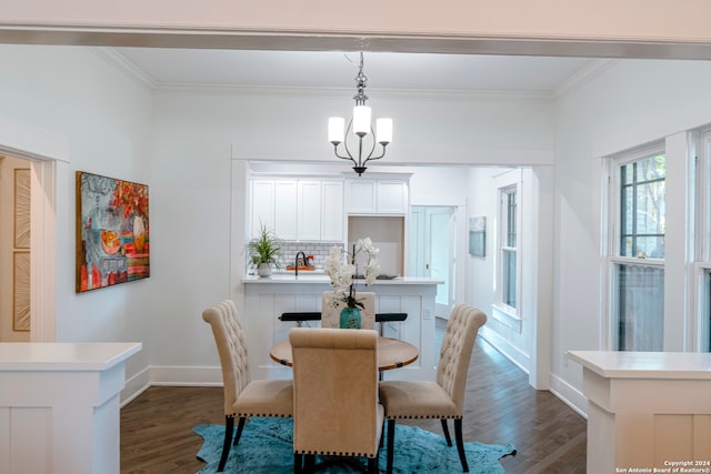 dining room with ornamental molding, a notable chandelier, and dark hardwood / wood-style flooring