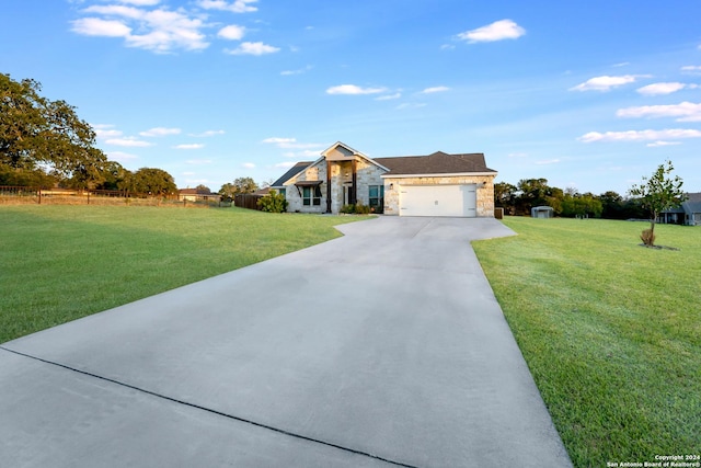 120CHAMPIONSB Champions Blvd, La Vernia, TX 78121 - view of front of house featuring concrete driveway, a front yard, stone siding, and a garage
