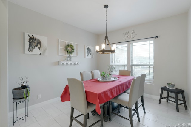 tiled dining area with a chandelier