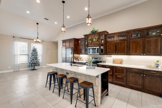 120CHAMPIONSB Champions Blvd, La Vernia, TX 78121 - kitchen featuring a kitchen bar, appliances with stainless steel finishes, a sink, light countertops, and a center island with sink