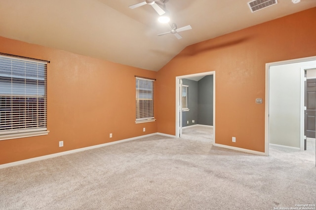 carpeted empty room featuring ceiling fan and vaulted ceiling