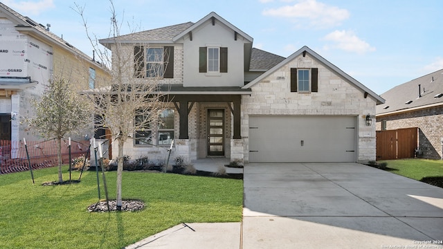 view of front of property with a front yard and a garage